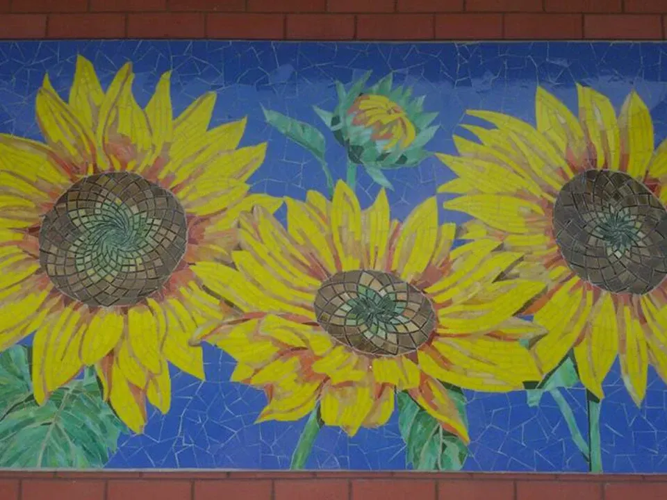 8 by 4 feet stained glass sunflower mosaic above a residence entrance in Ahmedabad