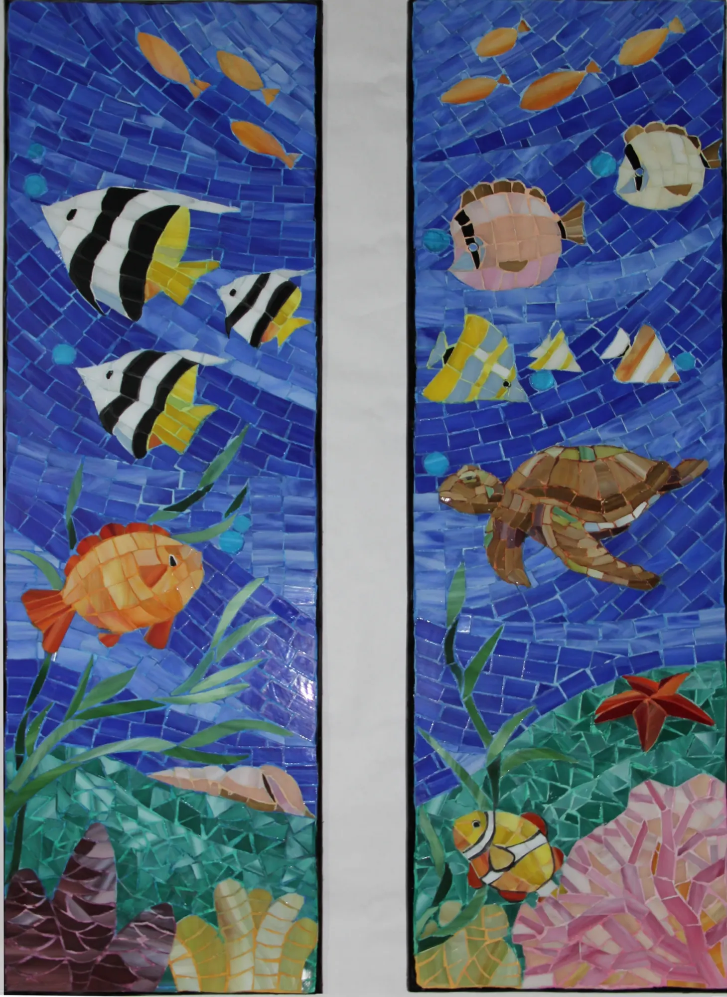 Two seascape mosaic panels with tropical fish and a turtle